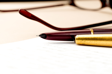 vintage fountain pen on a letter, glasses behindの写真素材