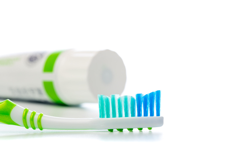 toothbrush and toothpaste tube on an isolated background