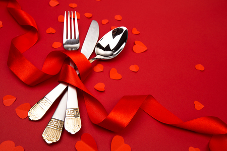 Fork knife spoon with ribbon on red - Imageの写真素材