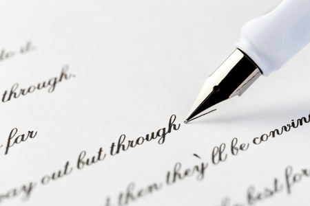 white fountain pen writing a letter