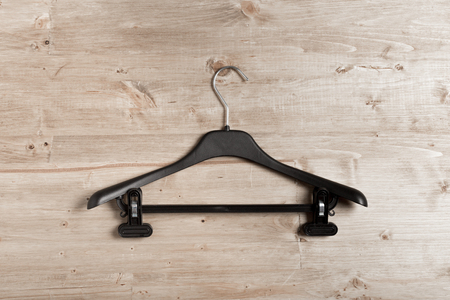 black coat hanger on wooden backgroundの写真素材