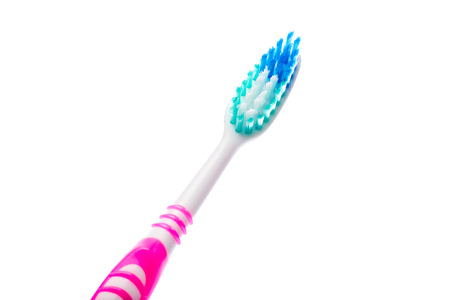 pink toothbrush on an isolated background, close upの写真素材