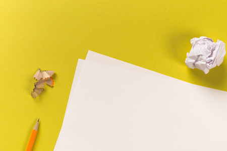 Pencils with sharpening shavings with white paper sheets on coloured backgroung, Office tool, rolled paperの写真素材