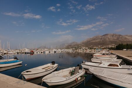 Bar, Montenegro - November 31, 2018. fishing boats on the background of mountains and yachts on the Adriatic coast. - Imageのeditorial素材