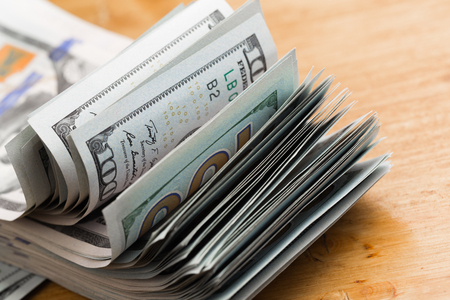 Close-up american dollar banknotes on wooden table