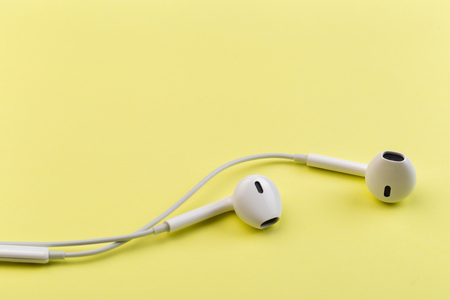 white earphones on yellow backgroundの写真素材