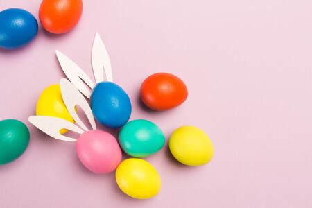 easter eggs on pink background, top view