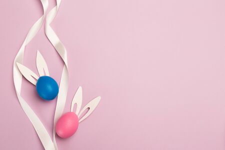 easter eggs on pink background, top view