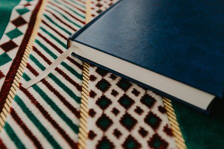 Islamic concept - The holy Quran on a praying matt