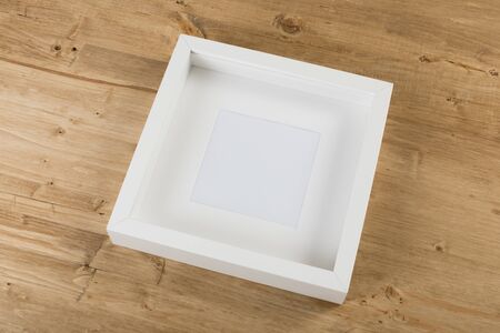 white frame on wooden backgroundの写真素材