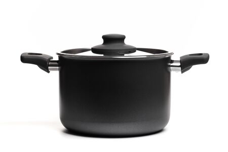 Open stainless steel cooking pot with lid over white background -...
