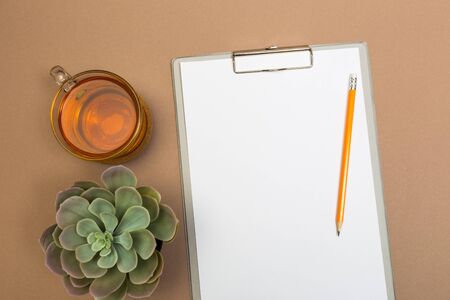office desk table with  clipboard  tea and succulent. Mock up template . Top view.- Imageの写真素材