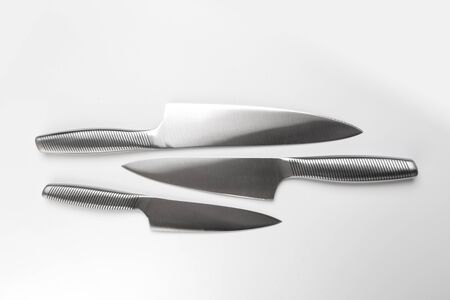 Set of steel kitchen knives on white background . - Image