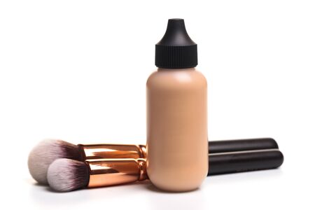 Close-up of flat makeup brush with liquid foundation tube isolated on white - Imageの写真素材