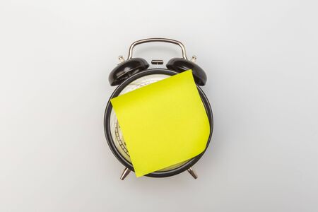 paper stick on clock for notice something with white background - Imageの写真素材