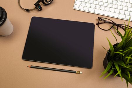 office desk table with  tablet  keyboard headphones coffee and glasses Mock up template . Top view.-...