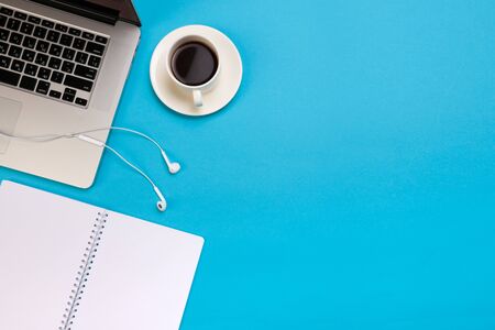 Office desk working space - Flat lay top view mockup photo of a working space with laptop, coffee cup and smartphone on blue pastel background. Pastel blue color copy space working desk concept. - Imageの写真素材