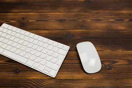 Modern  keyboard on the wooden table with mouse  in the office - Imageの写真素材