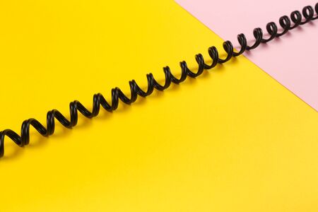 black curl cable socket on pastel colour background -  Imageの写真素材