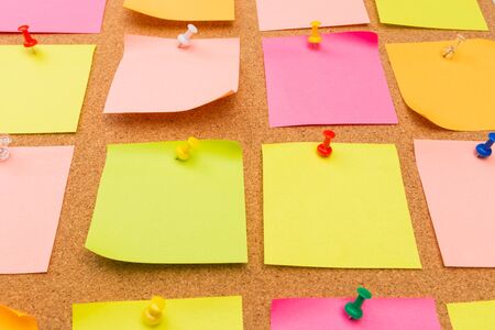 Cork board with pinned colored blank notes - Image