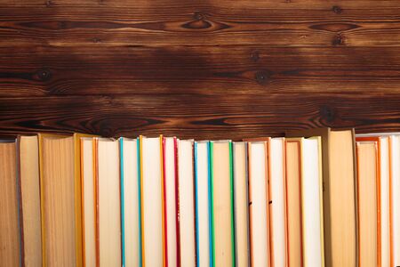 Stack of books on a wooden background.Education. - Imageの写真素材