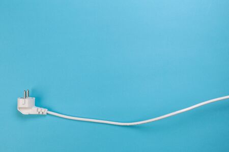 white power cable socket on blue background -  Imageの写真素材