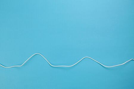 white power cable socket on blue background -  Imageの写真素材