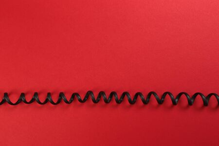 Curl black wire on red background - Image