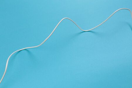 white power cable socket on blue background -  Imageの写真素材