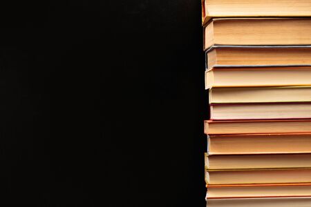 Stack of books on a black  background.Education. - Image