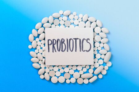 probiotics white  dragee on blue backgroundの写真素材