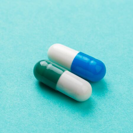 colour tablets and pills on blue background - Image