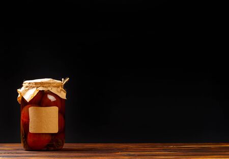 glass bottle with preserved food on black background - Imageの写真素材