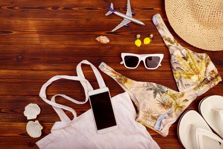 Vacation travel equipment Straw hat, sunglasses And marine objects, shells, on wooden floorの写真素材
