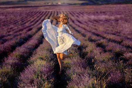 Beautiful girl on the lavender field. Beautiful woman in the lavender field on sunset. - Imageの写真素材
