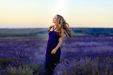Beautiful girl on the lavender field. Beautiful woman in the lavender field on sunset. - Imageの写真素材