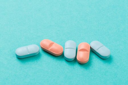 colour tablets and pills on blue background - Imageの写真素材