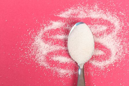 Sugar spoon on pastel  background. - Image