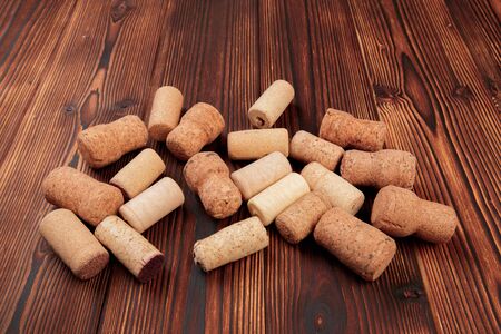 wine corks on a dark wooden background texture with a place for text.の写真素材