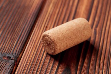 wine corks on a dark wooden background texture with a place for text.