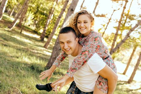 Happy young couple enjoying outdoors during sunsetの写真素材