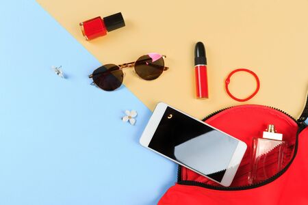 Top view of Women bag and lady stuff with copyspace on colour  backgroundの写真素材