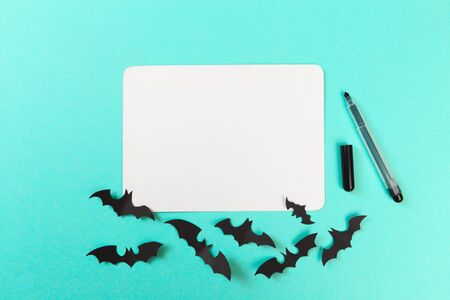 Halloween paper decorations on pastel blue  background. Halloween concept. Flat lay, top view, copy spaceの写真素材