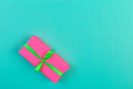 Gift box with ribbon and bow on color background and space for text. Top viewの写真素材
