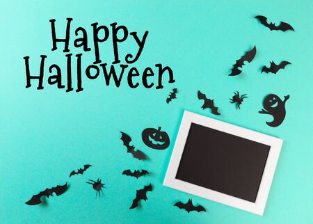 Halloween paper decorations on pastel blue  background. Halloween concept. Flat lay, top view, copy spaceの写真素材
