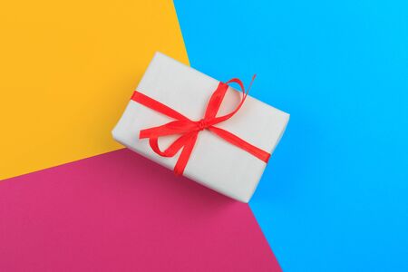 Gift box with ribbon and bow on color background and space for text. Top viewの写真素材