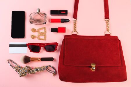 Top view of Women bag and lady stuff with copyspace on pink backgroundの写真素材