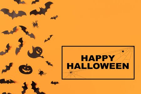 Halloween paper decorations on orange background. Halloween concept. Flat lay, top view, copy spaceの写真素材