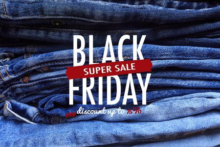 Jeans trousers stack closeup background texture. Black friday sale