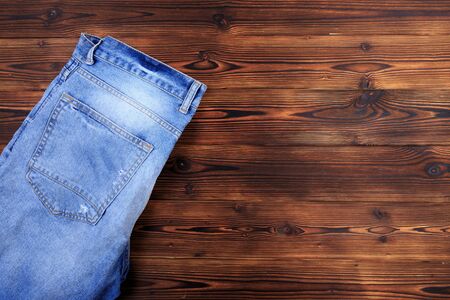 blue denim jeans  on wooden background - Image の写真素材